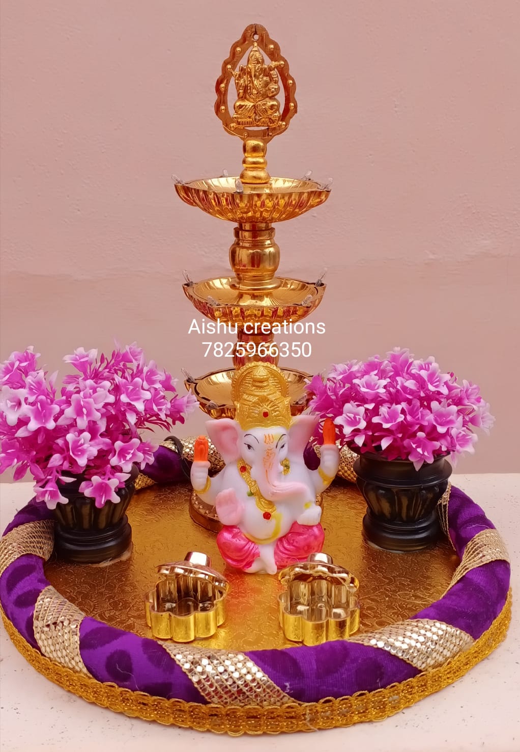 HANDCRAFTED PLATTER WITH VINAYAGAR AND TRADITIONAL STAND LAMP.